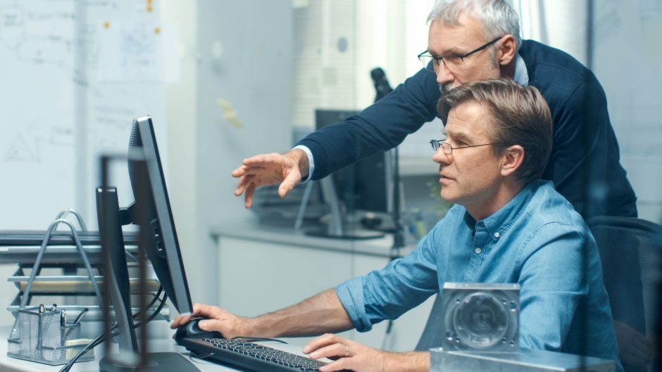 Engineers looking at a computer